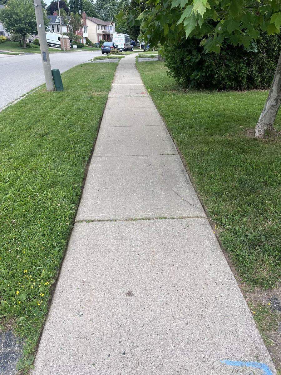 Front lawn and interlock driveway edge in Guelph